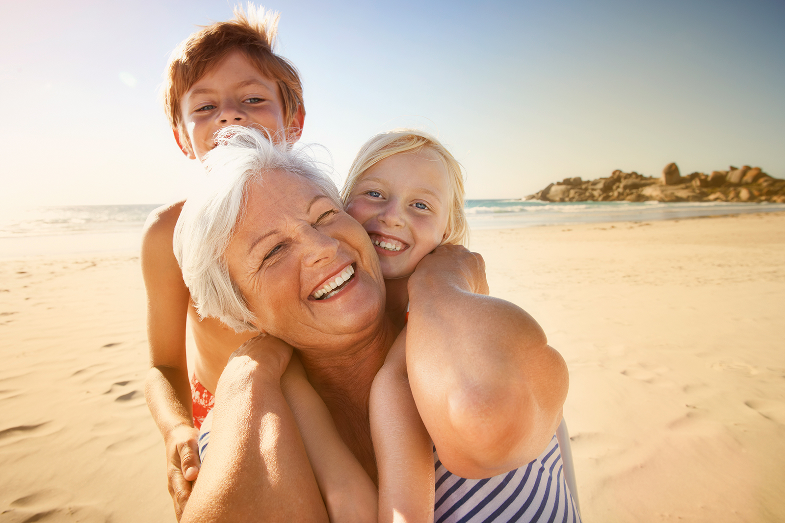 Grandmother_and_children_on_beach_CMYK